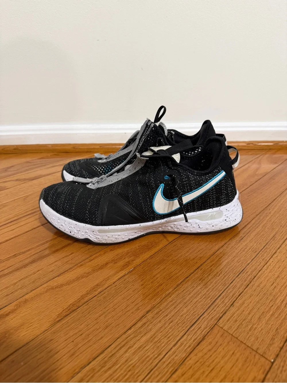 Nike Men’s Paul George 4 Black and White Sneakers with Teal Swoosh